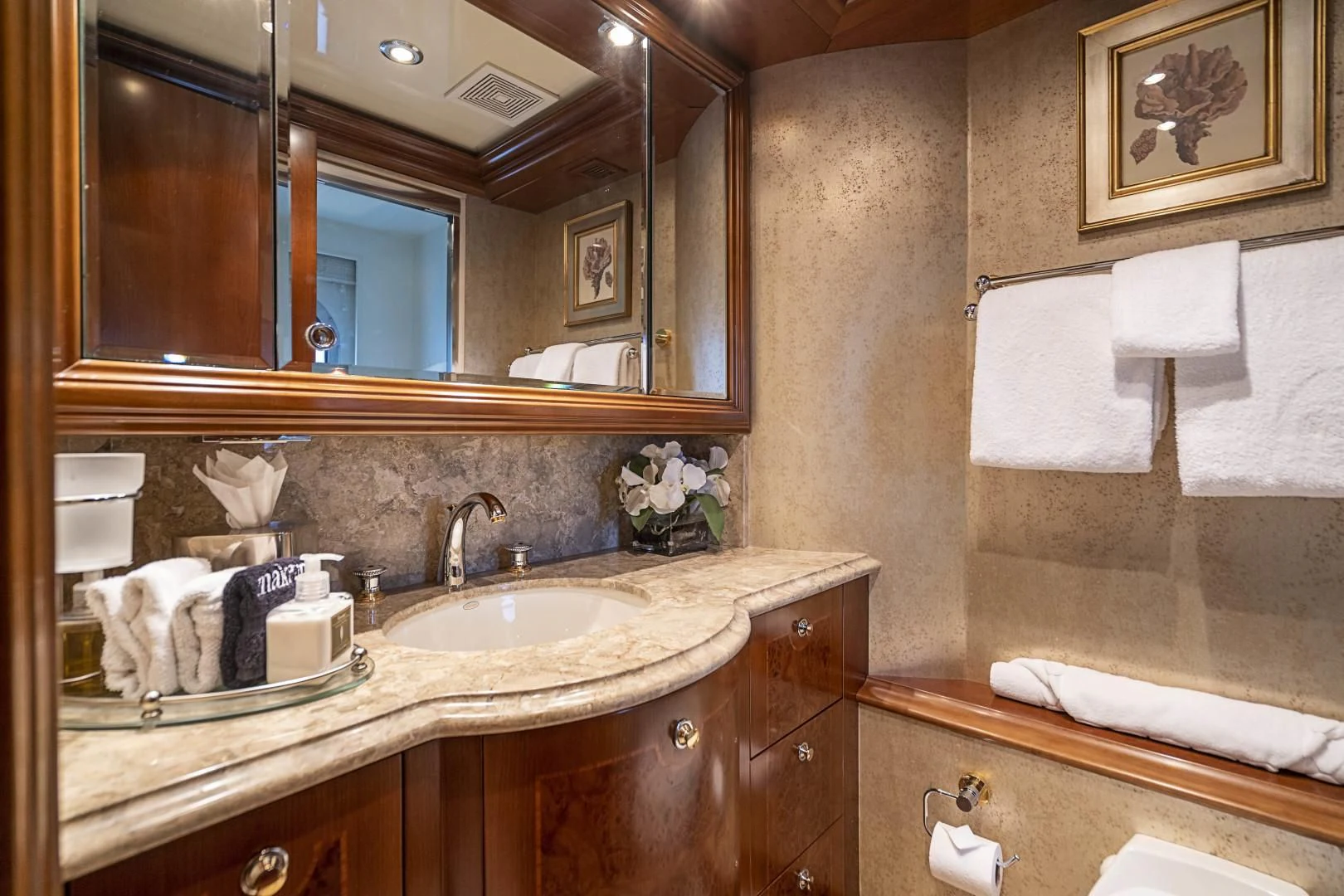 a bathroom with a large mirror aboard CAMILLE Yacht for Sale