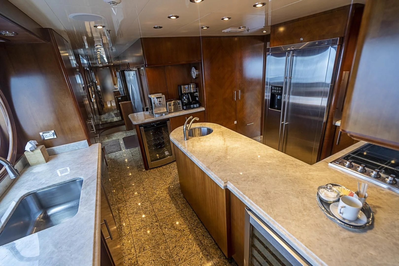 a kitchen with a stainless steel refrigerator aboard CAMILLE Yacht for Sale