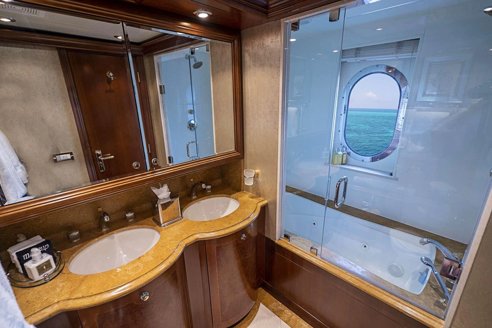 a bathroom with a large mirror aboard CAMILLE Yacht for Sale