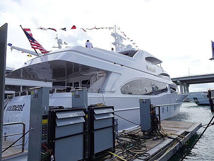 a large white boat with a flag on top aboard CAMILLE Yacht for Sale