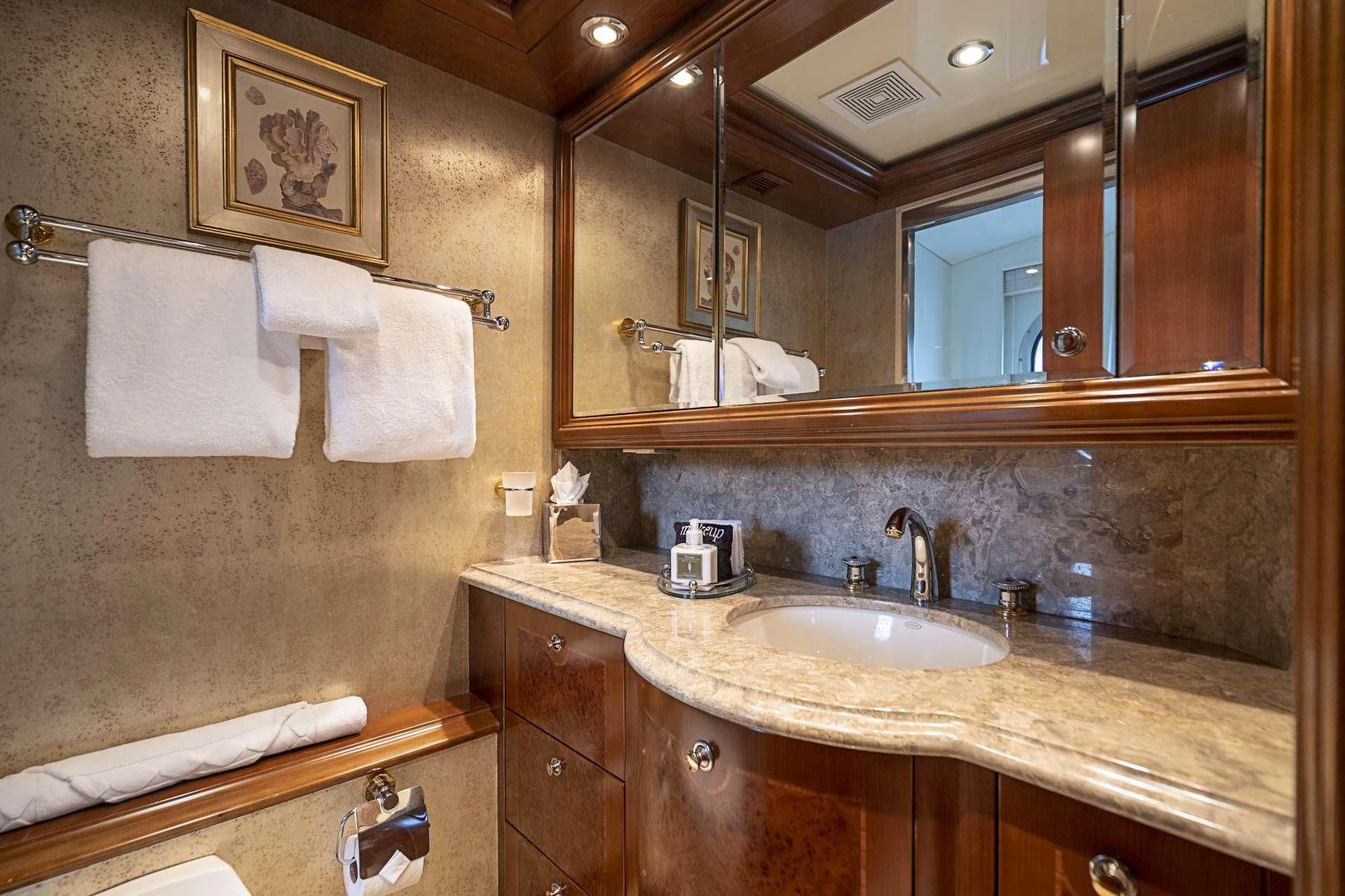 a bathroom with a large mirror aboard CAMILLE Yacht for Sale