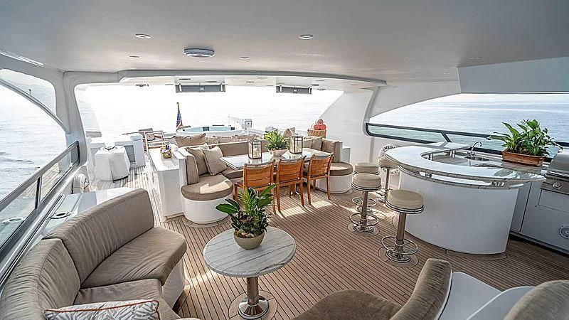 a living room with a kitchen and dining area aboard CAMILLE Yacht for Sale