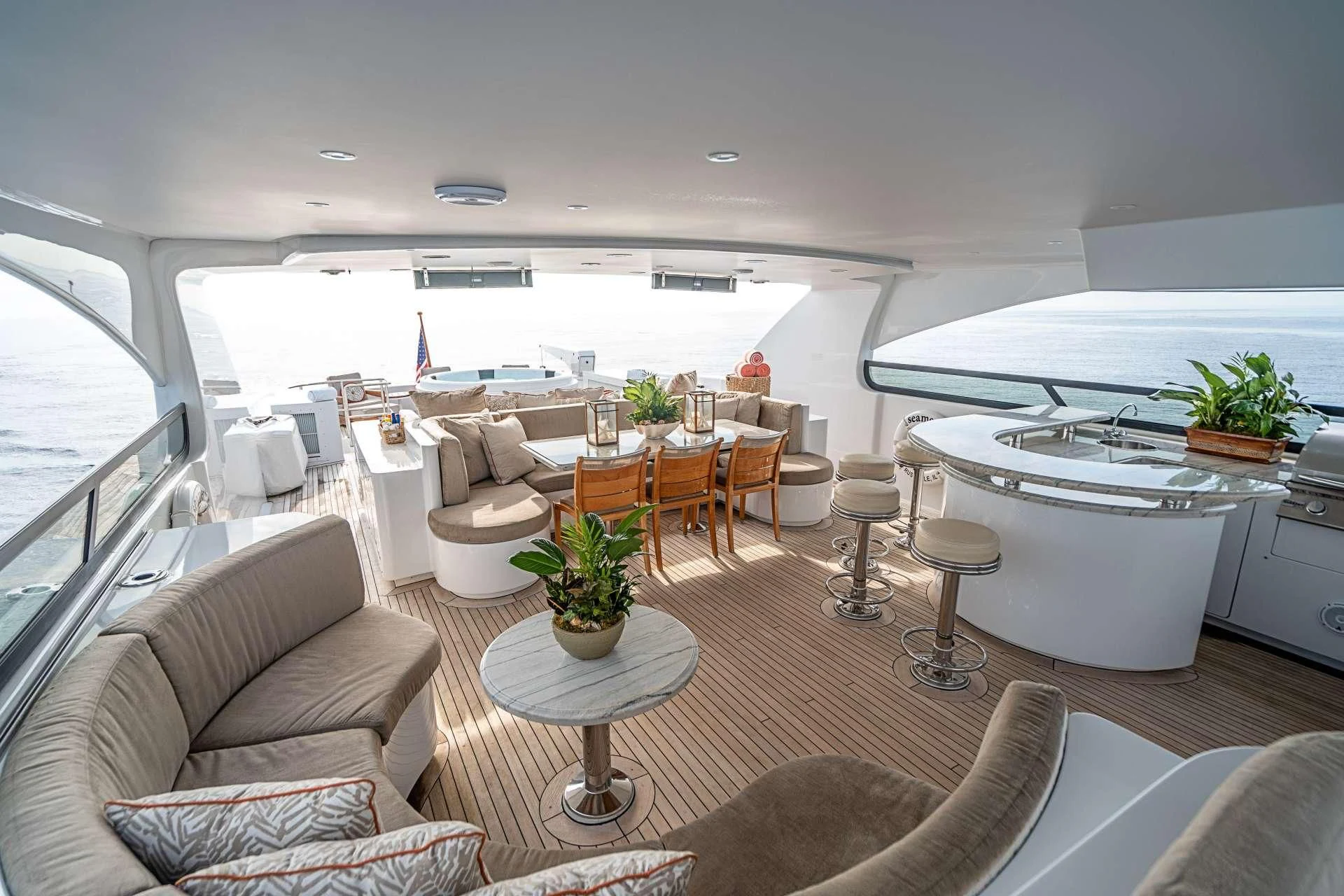 a living room with a large white table and chairs aboard CAMILLE Yacht for Sale
