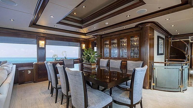 a room with a table chairs and a large window aboard CAMILLE Yacht for Sale