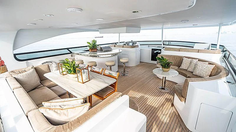 a living room with a large white table and couches aboard CAMILLE Yacht for Sale