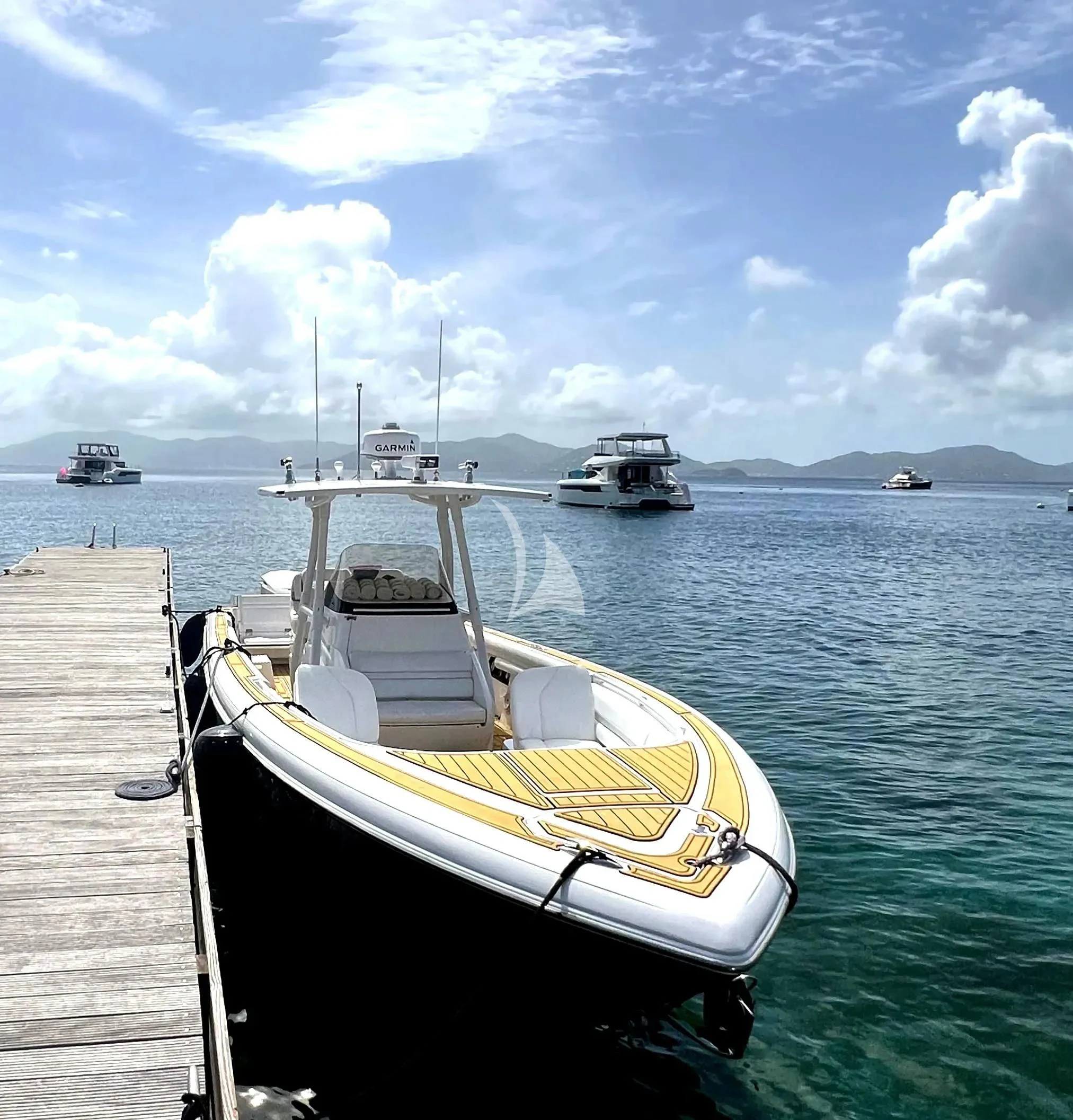 a yellow and white boat on a dock with other boats in the water aboard CAMILLE Yacht for Sale