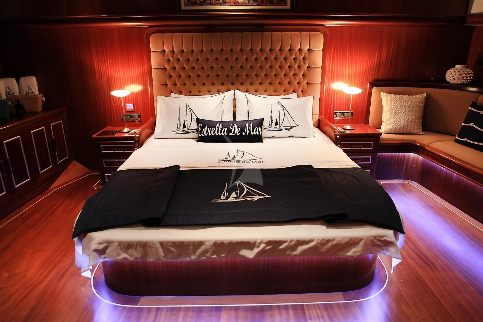 a bed with a black and white bed spread aboard ESTRELLA DE MAR Yacht for Sale