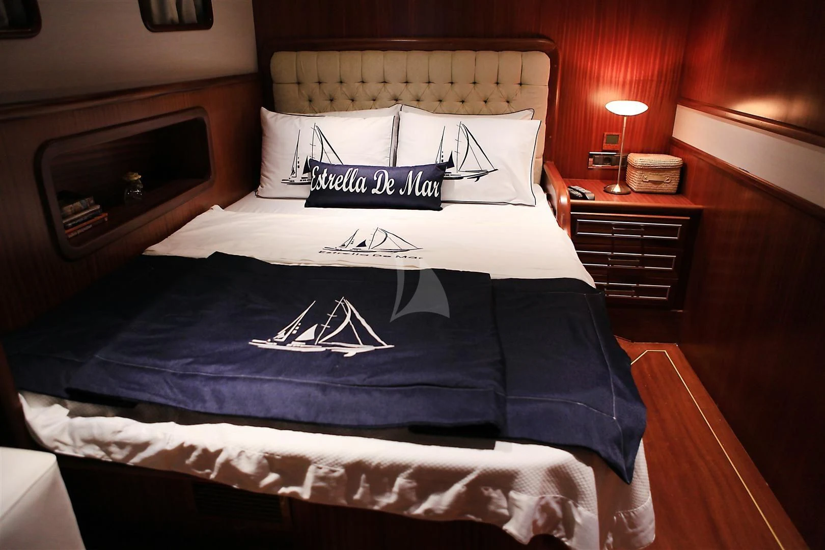 a bed with a blue sheet aboard ESTRELLA DE MAR Yacht for Sale
