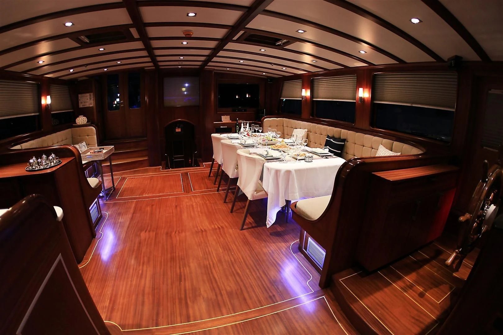 a room with tables and chairs aboard ESTRELLA DE MAR Yacht for Sale