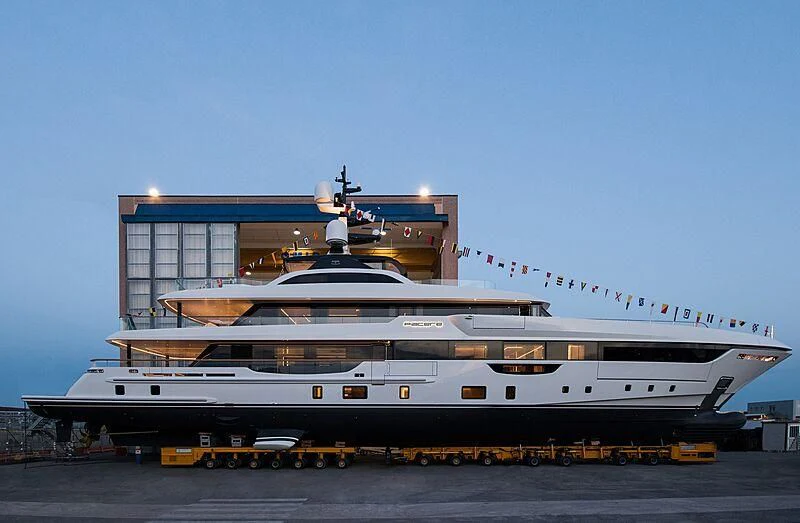 a large cruise ship docked aboard PIACERE Yacht for Sale