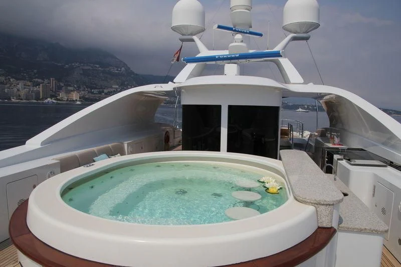 a white boat with blue water aboard LA BLANCA Yacht for Sale