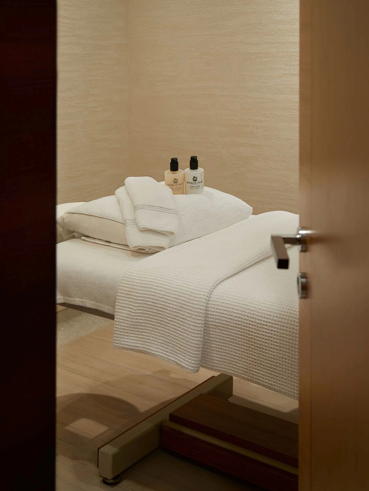 a bed with a bottle of wine on top aboard LA BLANCA Yacht for Sale