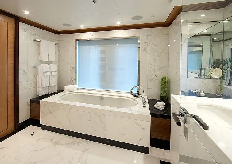 a bathroom with a tub sink and a large window aboard LA BLANCA Yacht for Sale