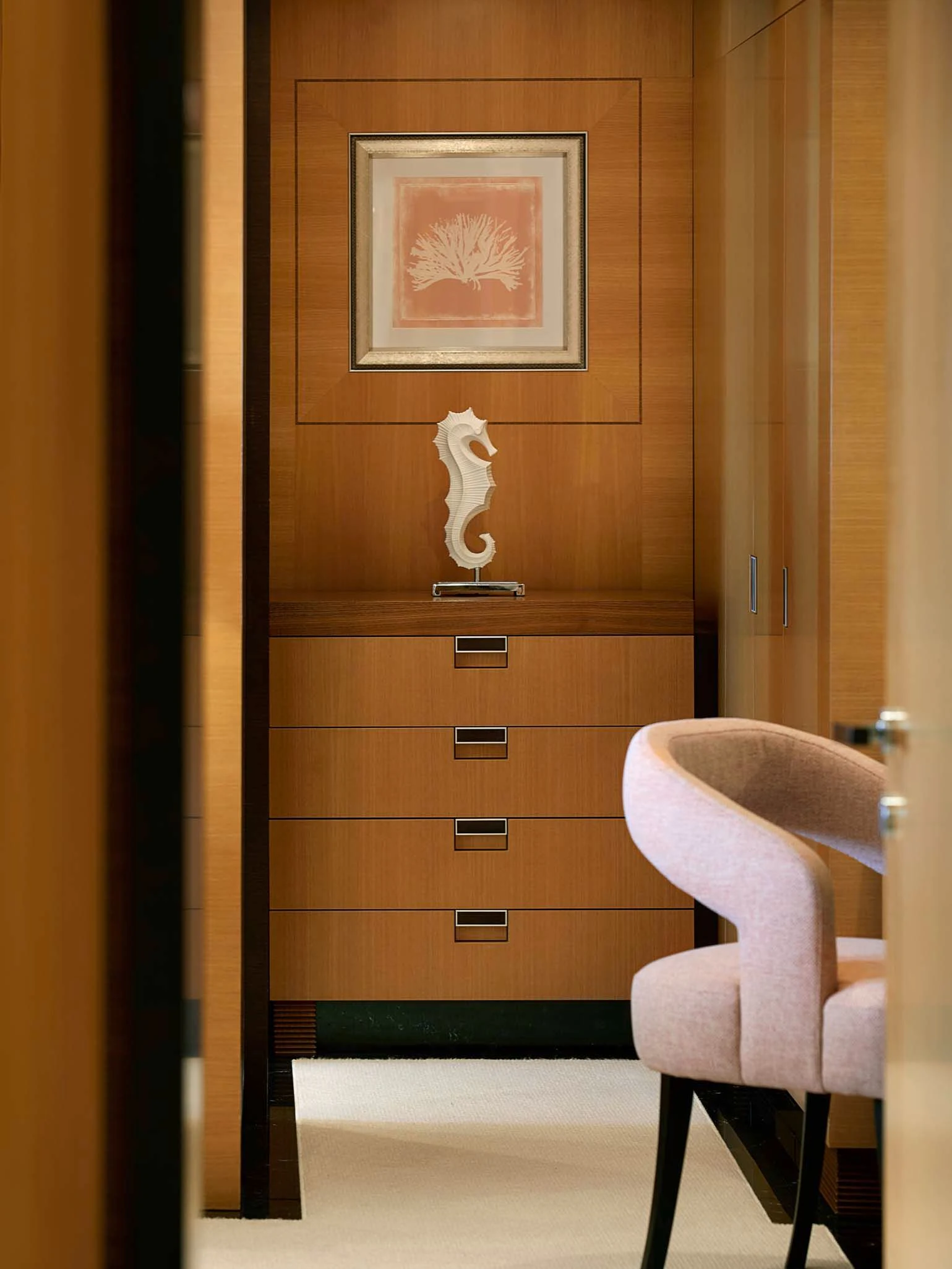 a room with a chair and a dresser and a picture on the wall aboard LA BLANCA Yacht for Sale