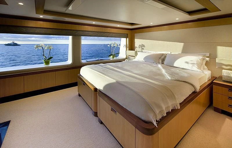 a bed with a white bed spread aboard LA BLANCA Yacht for Sale