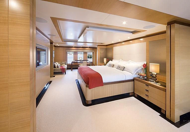 a bedroom with a bed and a desk aboard LA BLANCA Yacht for Sale