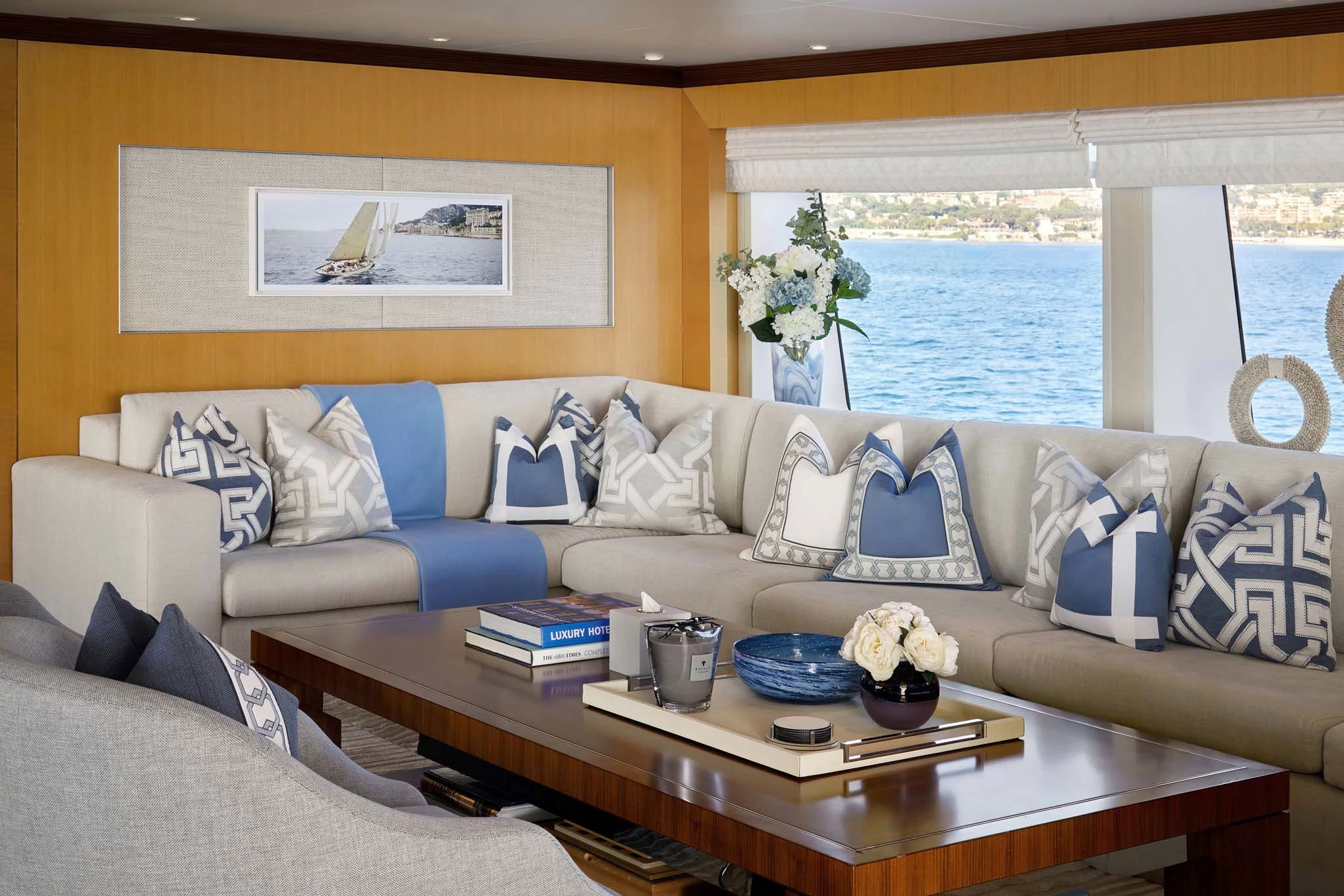 a living room with a couch and a table with a vase of flowers aboard LA BLANCA Yacht for Sale
