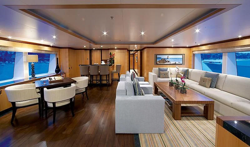 a living room with a large table and chairs aboard LA BLANCA Yacht for Sale