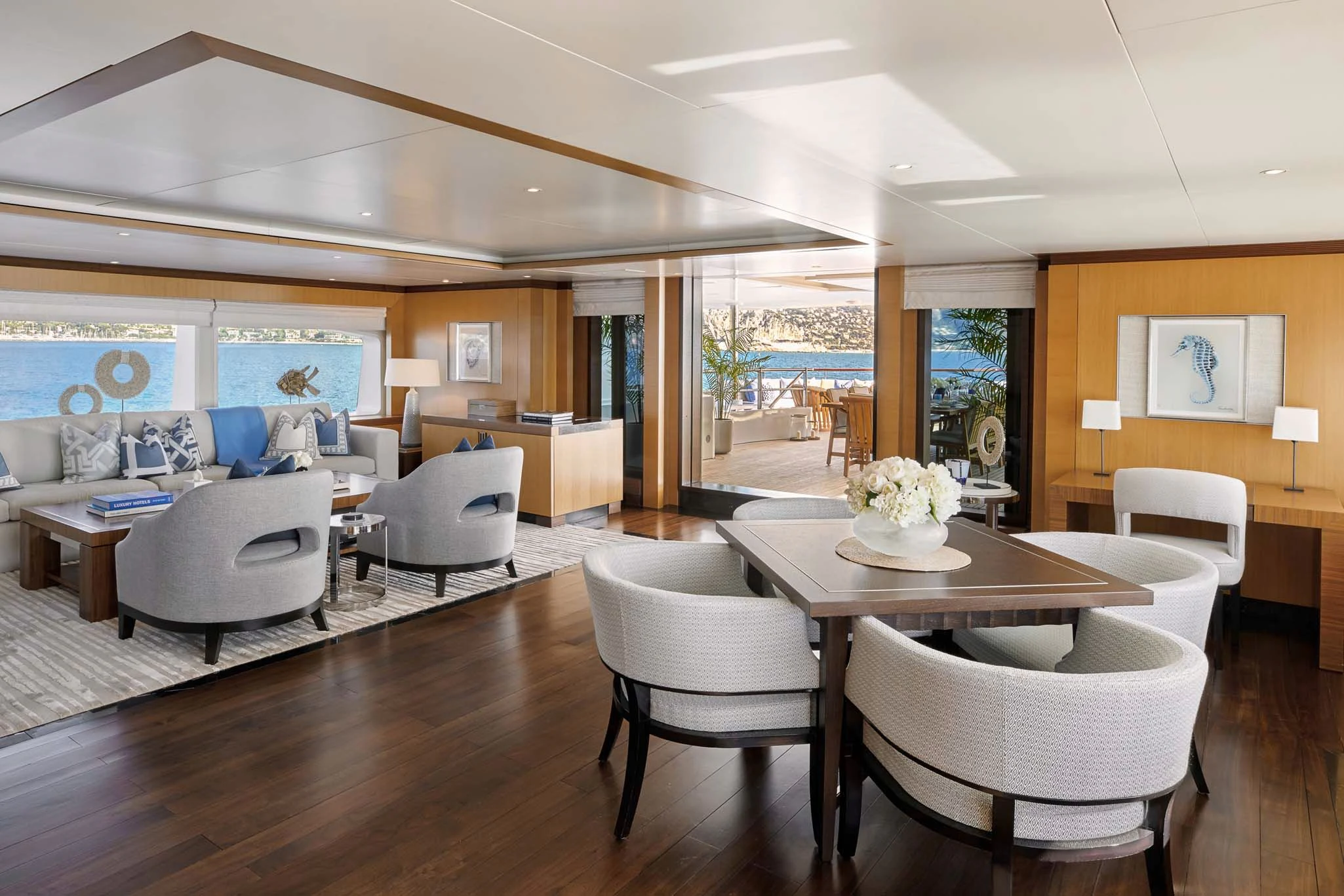 a living room with a table and chairs aboard LA BLANCA Yacht for Sale