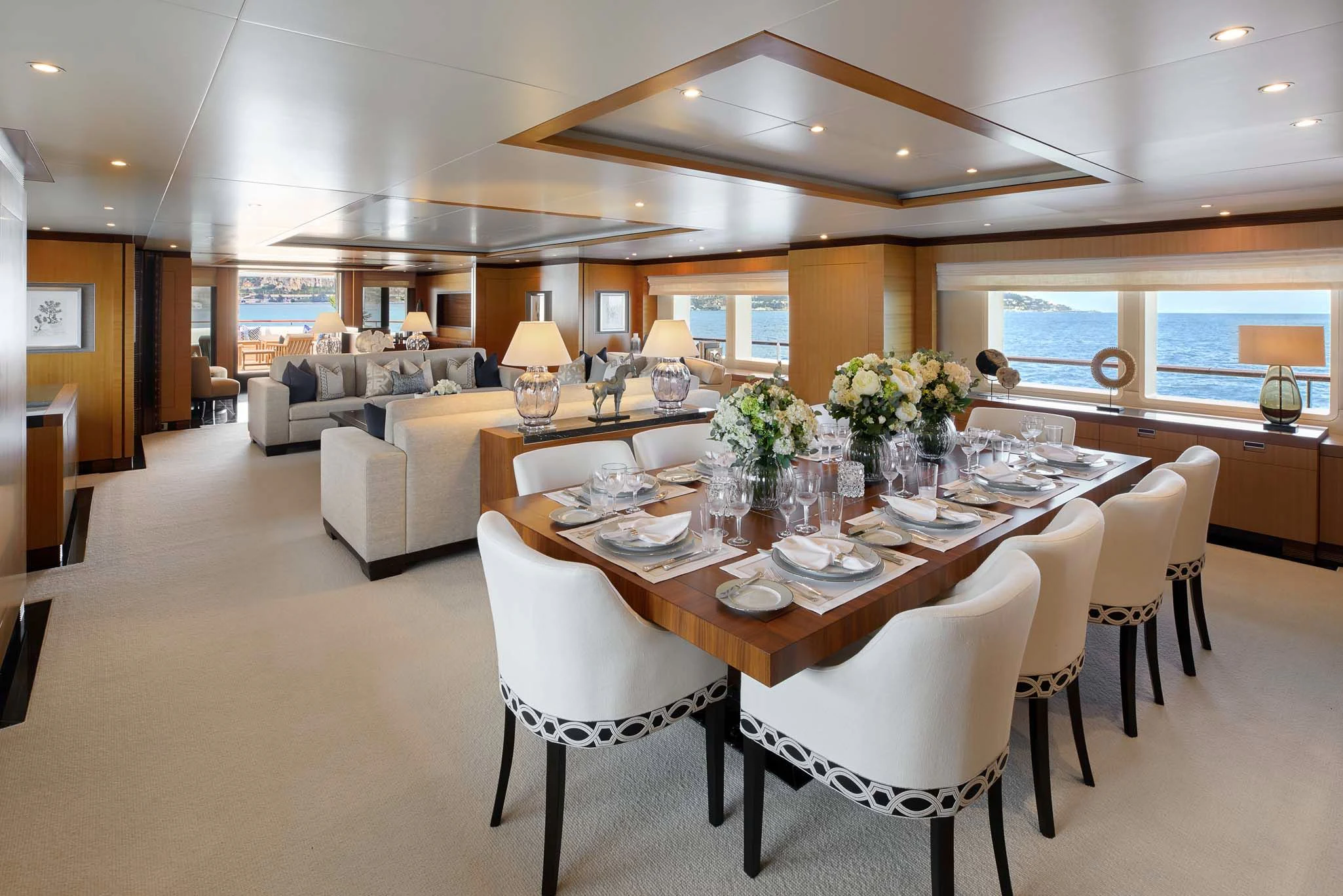 a large dining table in a large room with a large window aboard LA BLANCA Yacht for Sale