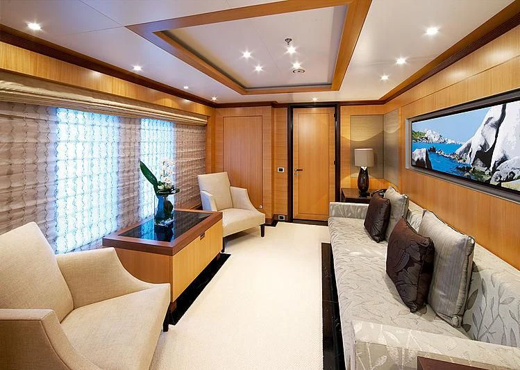 a living room with a large screen aboard LA BLANCA Yacht for Sale