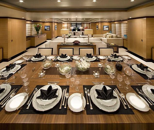 a table with plates and silverware aboard LA BLANCA Yacht for Sale