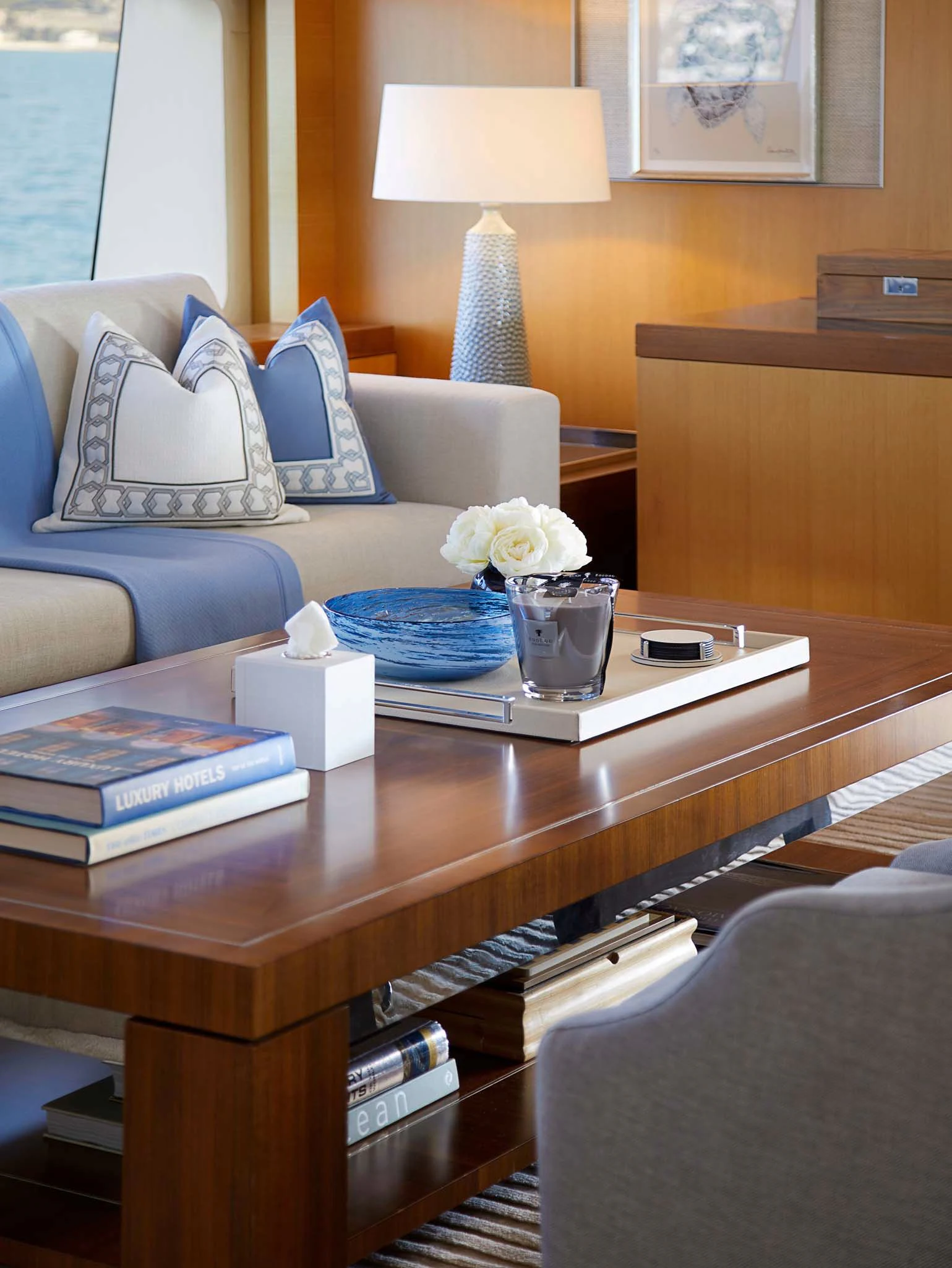 a coffee table with a blue couch and white pillows aboard LA BLANCA Yacht for Sale