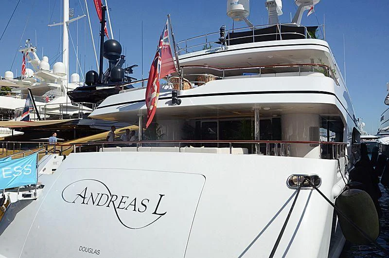 a large white boat with a red and blue stripe aboard LA BLANCA Yacht for Sale