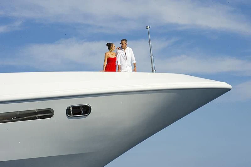 a man and woman standing on the nose of a plane aboard LA BLANCA Yacht for Sale