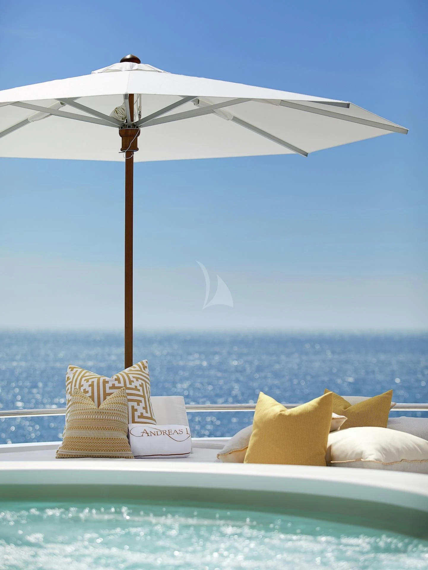 a bed with pillows and an umbrella aboard LA BLANCA Yacht for Sale