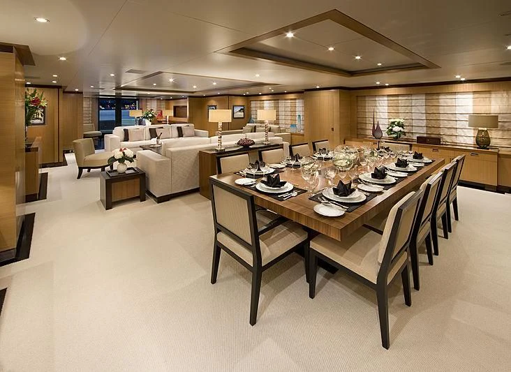 a large dining table in a large room aboard LA BLANCA Yacht for Sale