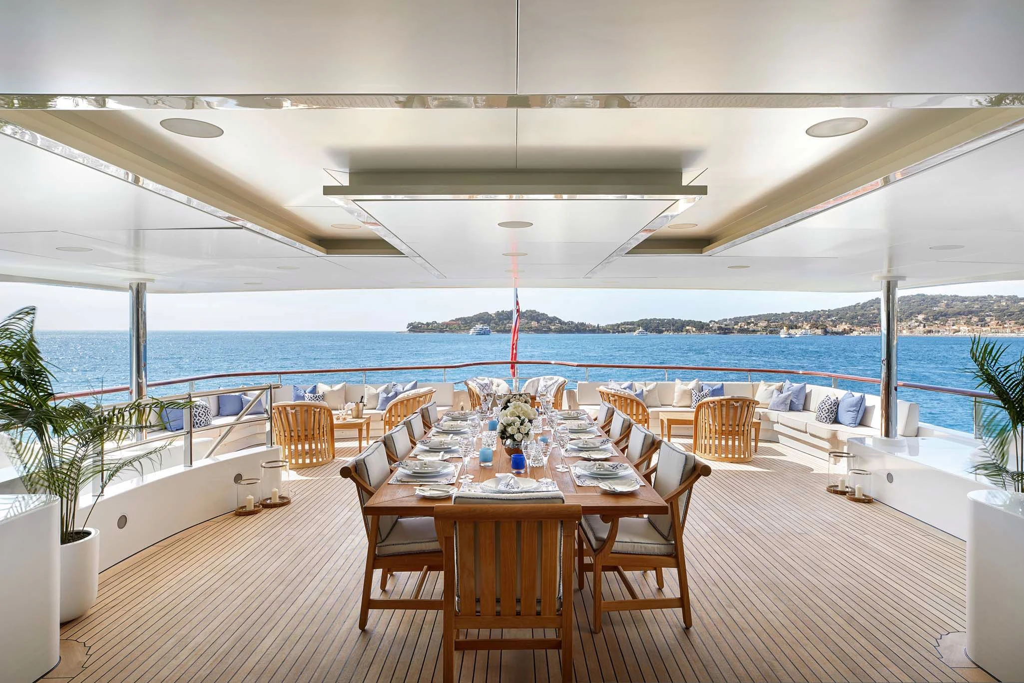 a table set for a meal on a deck overlooking the ocean aboard LA BLANCA Yacht for Sale