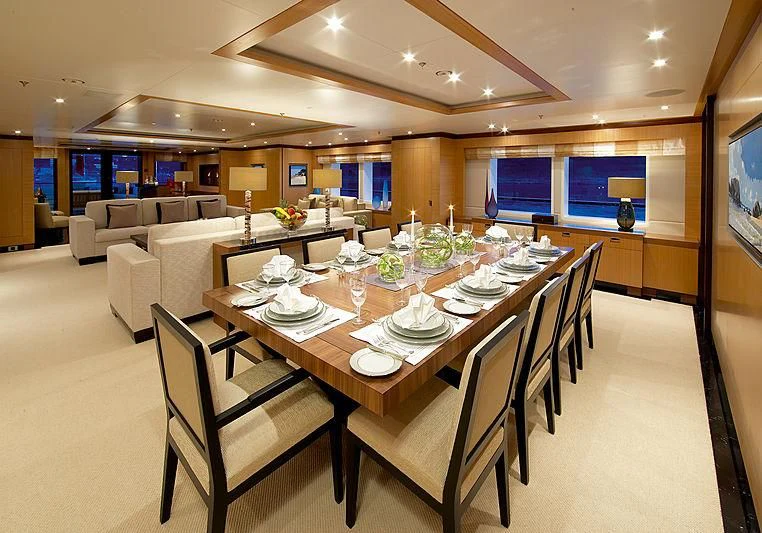 a dining room with a table and chairs aboard LA BLANCA Yacht for Sale