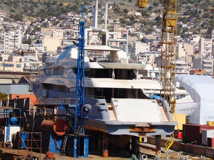 a large white boat in a harbor aboard BLUE DESIRE Yacht for Sale
