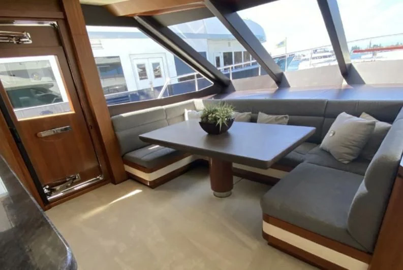 a living room with a couch and a coffee table aboard WICKED II Yacht for Sale