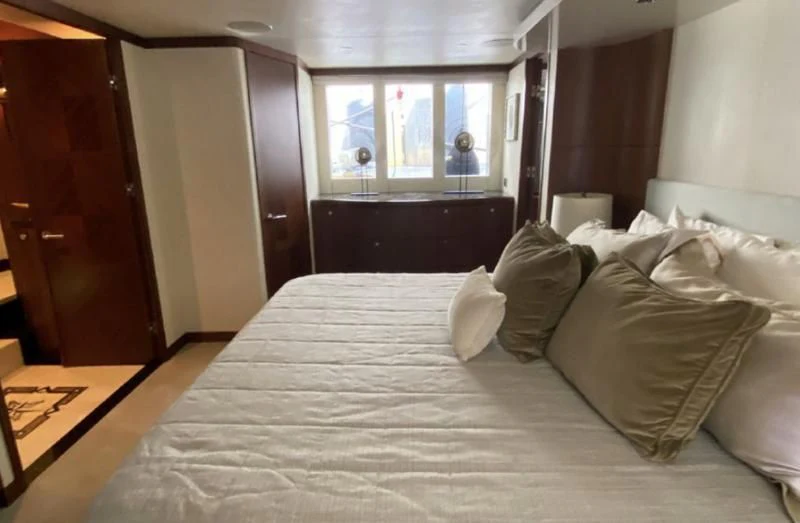 a bed with white sheets aboard WICKED II Yacht for Sale