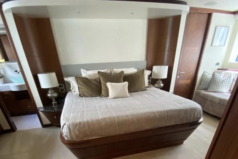 a bed with a white bed spread aboard WICKED II Yacht for Sale