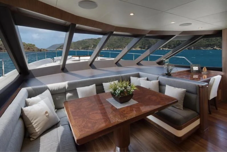 a room with a table and chairs aboard WICKED II Yacht for Sale