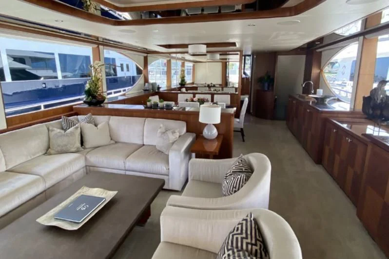 a living room with a couch and a table aboard WICKED II Yacht for Sale