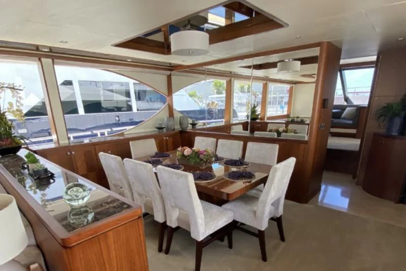 a dining room with a table and chairs aboard WICKED II Yacht for Sale