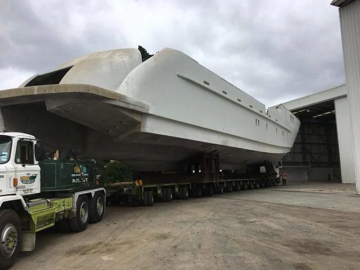 a large white truck with a large flatbed trailer aboard SENSATION YACHTS SY32 Yacht for Sale