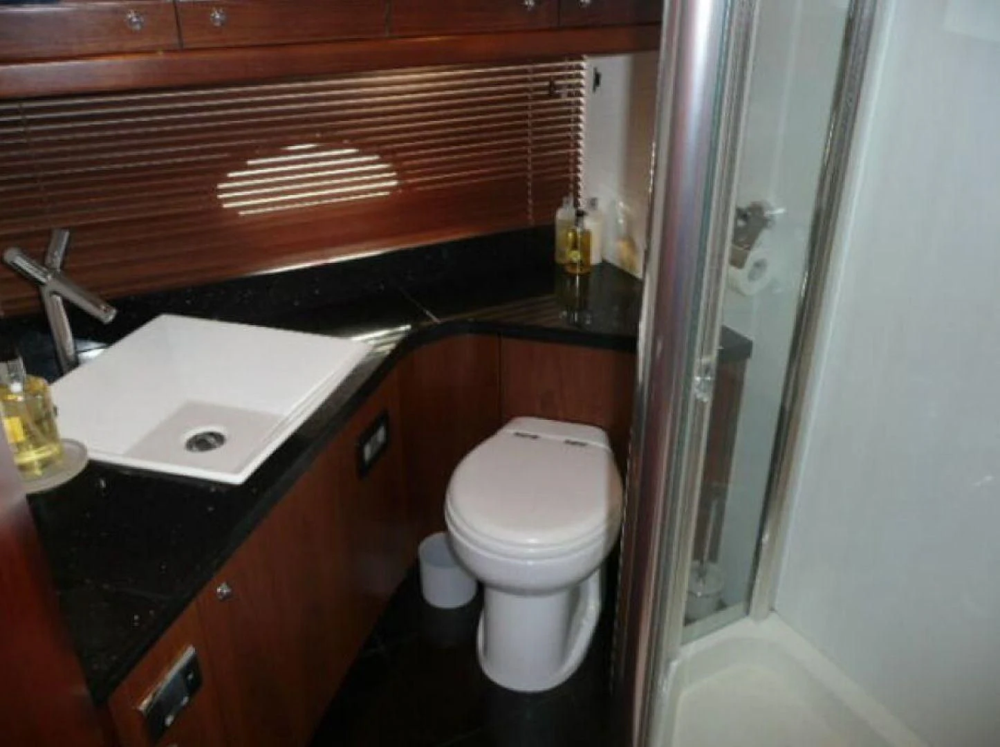 a bathroom with a toilet and sink aboard PURA VIDA Yacht for Sale
