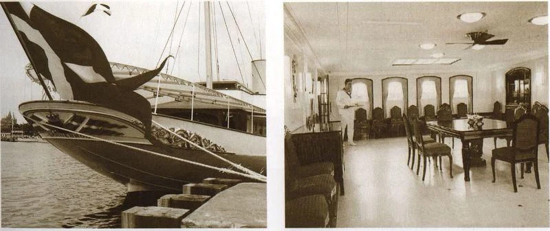 a large room with a table and chairs and a large whale in the water aboard DANNEBROG Yacht for Sale