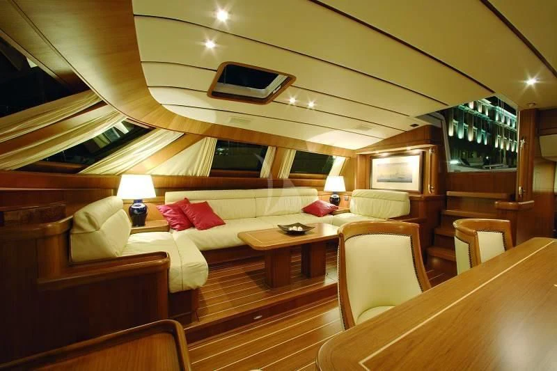 a room with a bed and a table aboard STARFALL Yacht for Sale