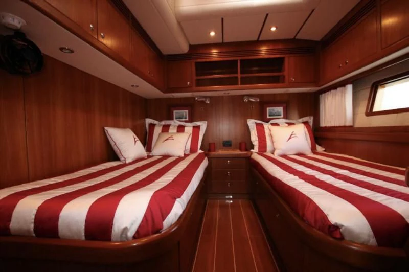 a room with beds and a wood wall aboard STARFALL Yacht for Sale
