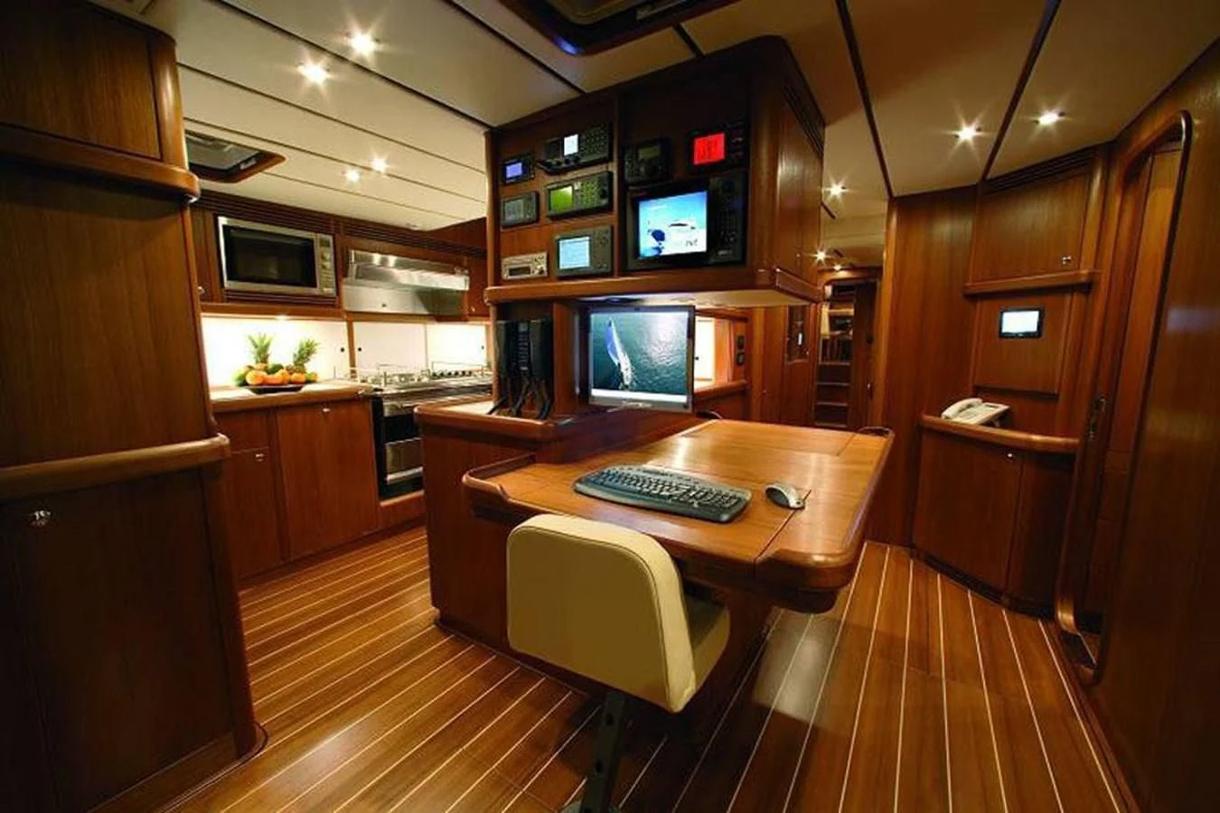 a kitchen with a wood floor aboard STARFALL Yacht for Sale