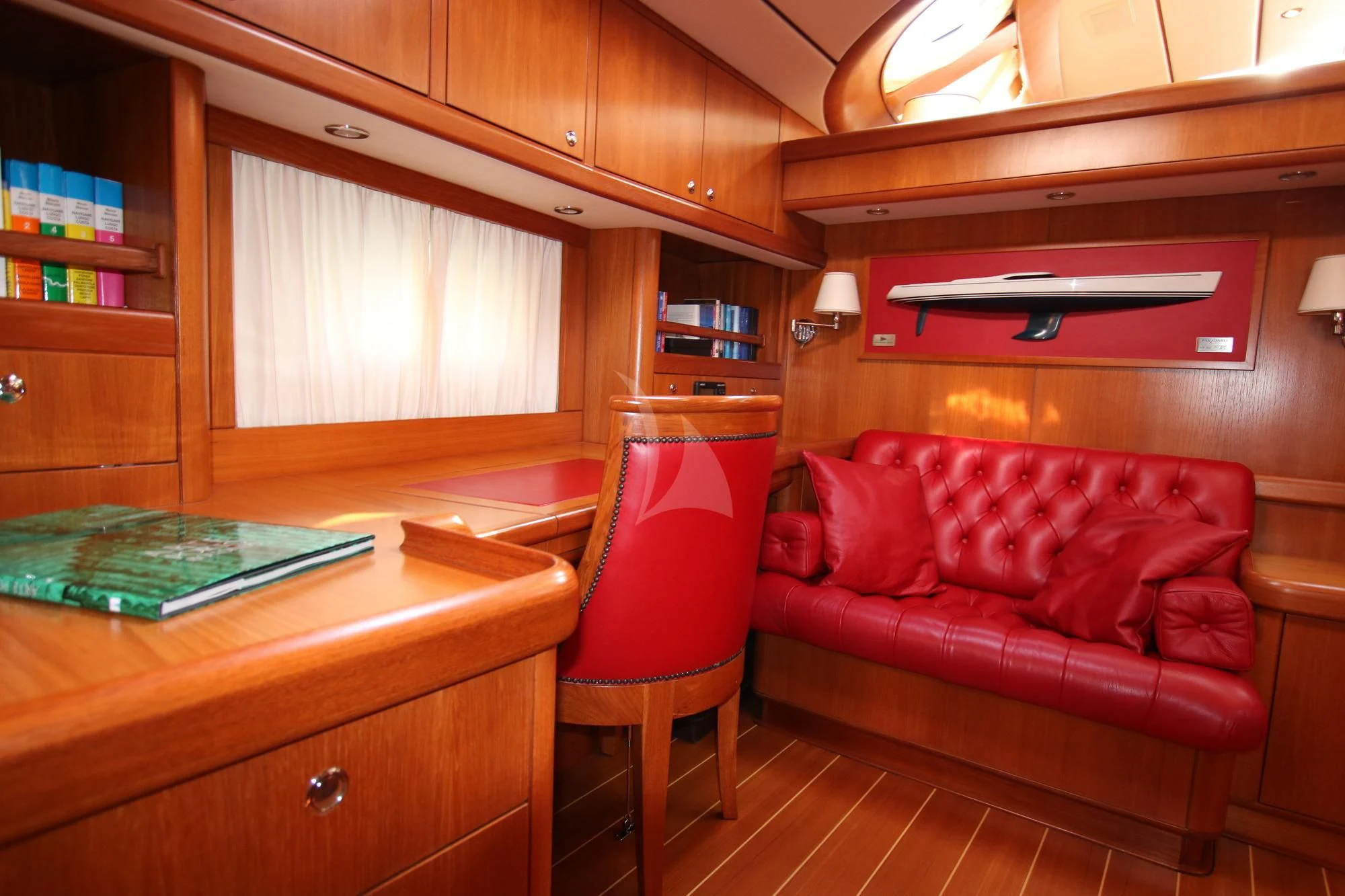 a living room with a red couch aboard STARFALL Yacht for Sale