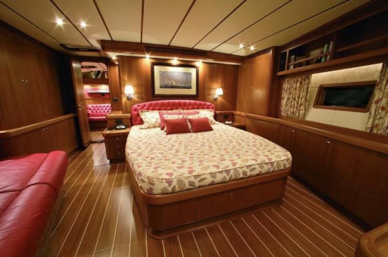 a bedroom with a bed and a mirror aboard STARFALL Yacht for Sale