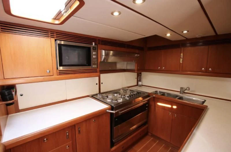 a kitchen with wooden cabinets aboard STARFALL Yacht for Sale