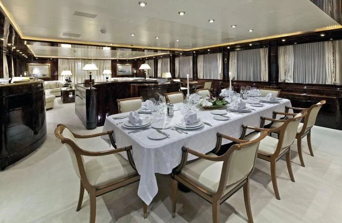 a dining room with a table set aboard O'RION Yacht for Charter